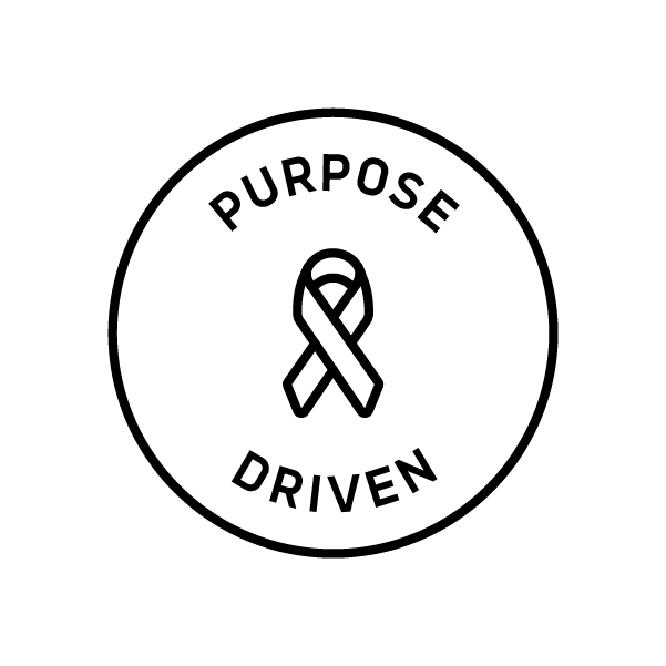 A circular logo with the words "Purpose Driven" written around the outer edge. Inside the circle, there is an icon of a ribbon. The logo is black on a white background.